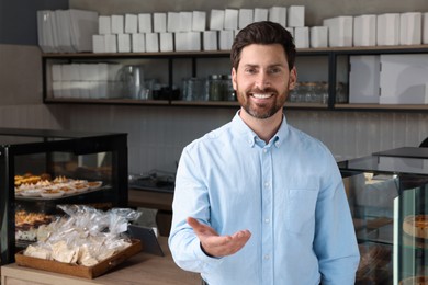 Photo of Portrait of happy business owner in bakery shop