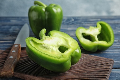 Wooden board with cut paprika pepper on table, closeup