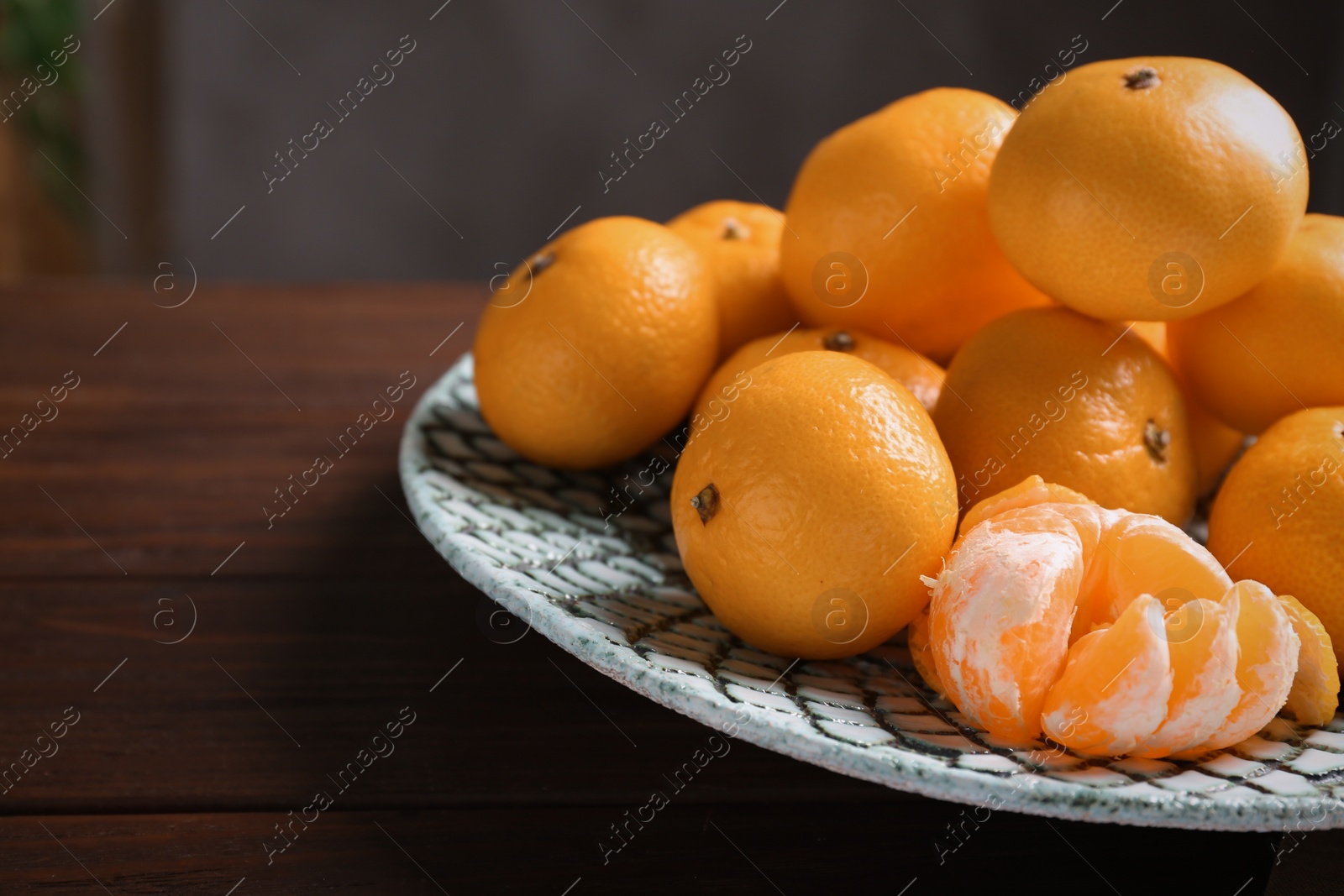 Photo of Fresh tangerines on wooden table. Citrus fruit