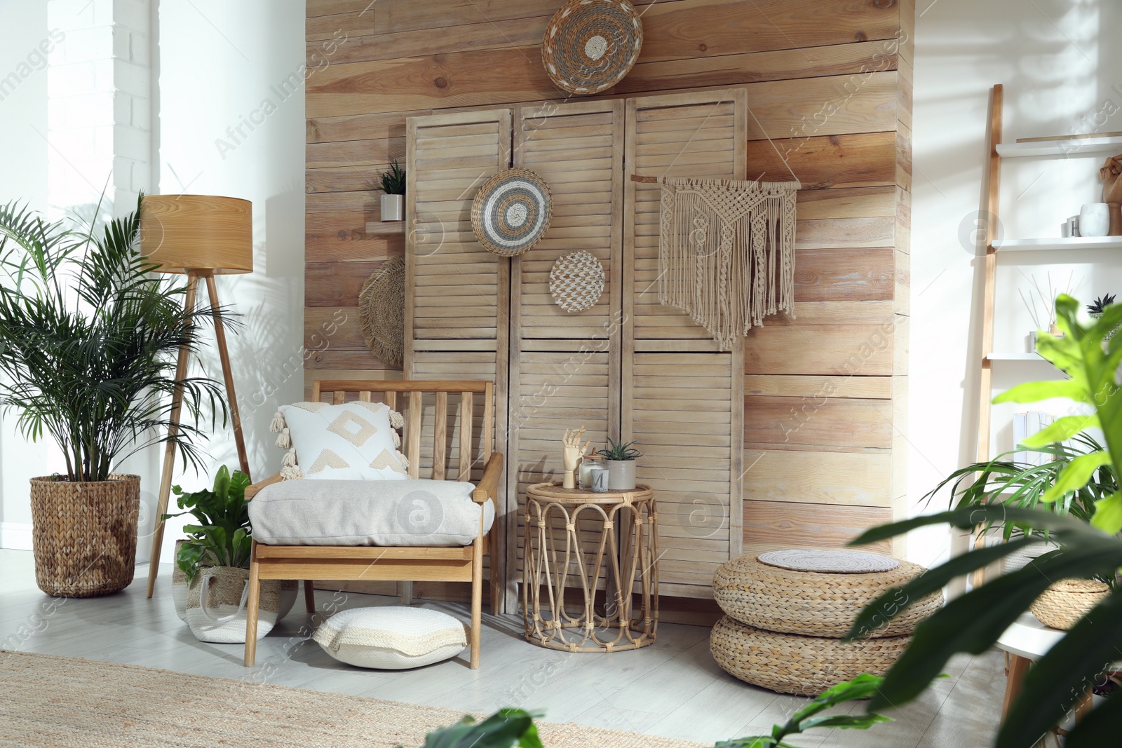 Photo of Stylish living room interior with comfortable wooden armchair and beautiful houseplants