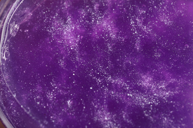 Photo of Closeup view of purple slime with glitter. Antistress toy