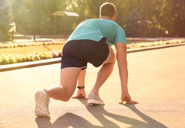 Young man ready for running outdoors on sunny day