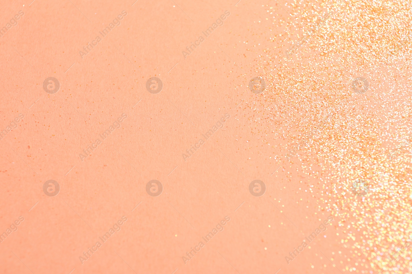 Photo of Shiny bright glitter on pink background, flat lay. Space for text