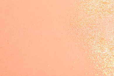 Photo of Shiny bright glitter on pink background, flat lay. Space for text