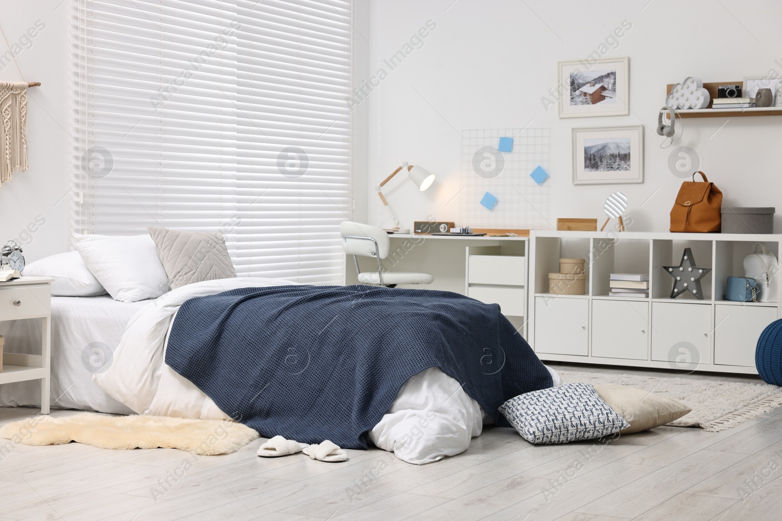 Photo of Bedroom interior with comfortable furniture, big window and white blinds