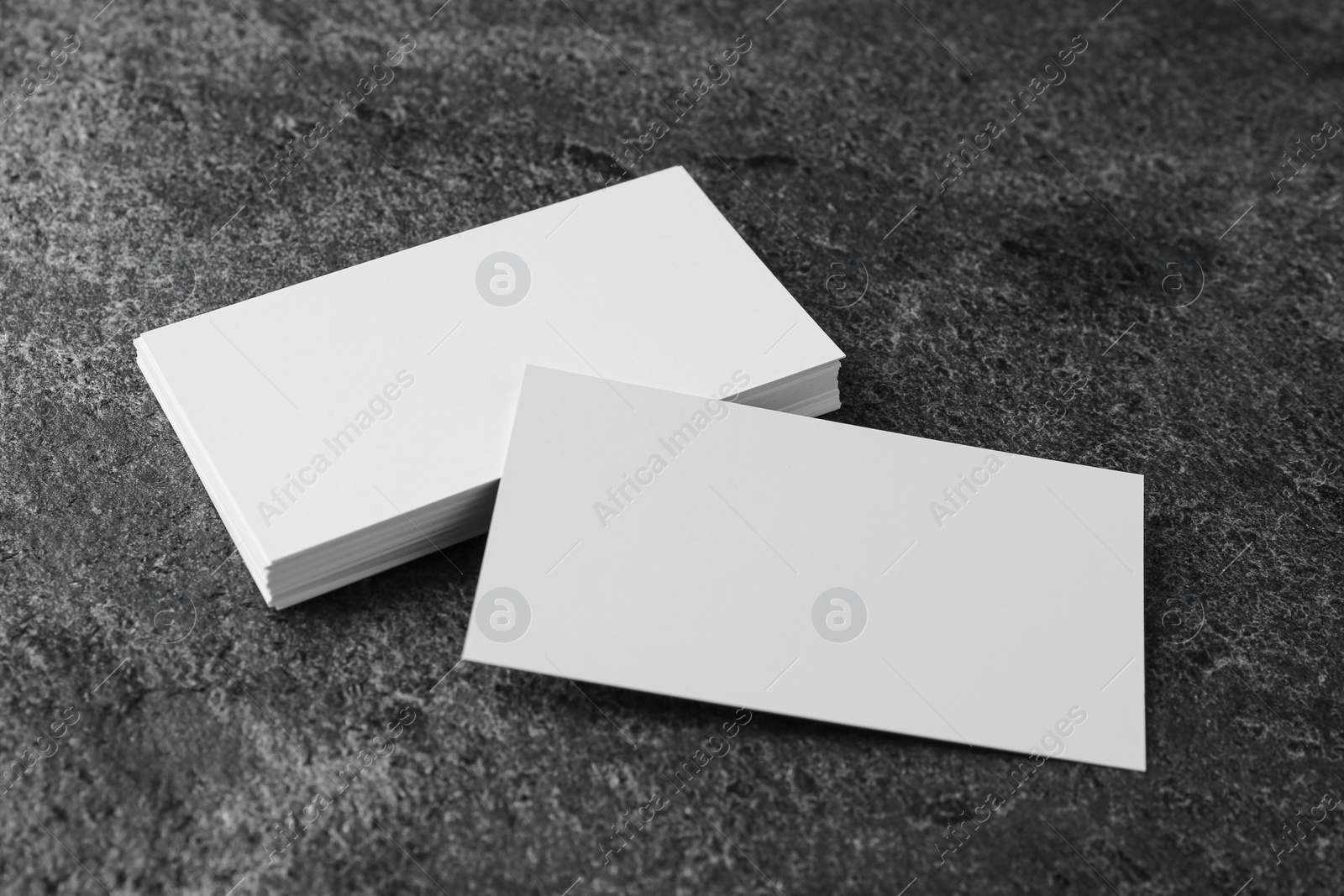 Photo of Blank business cards on grey table. Mockup for design