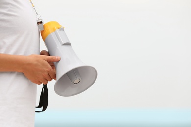 Photo of Female lifeguard with megaphone outdoors, closeup view
