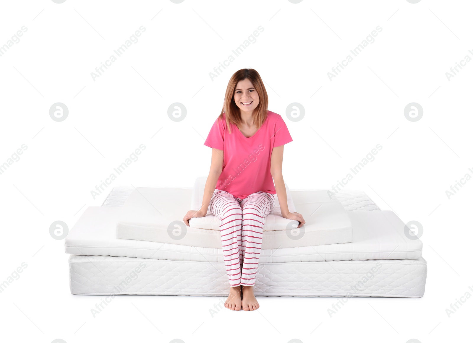 Photo of Woman sitting on mattress pile against white background