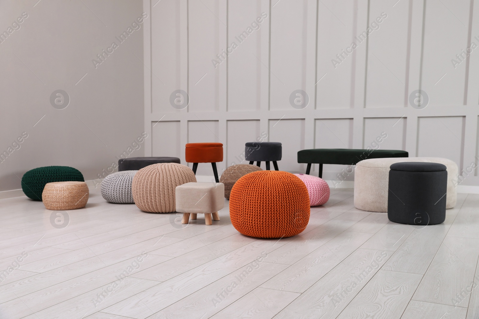 Photo of Different stylish poufs and ottomans in room