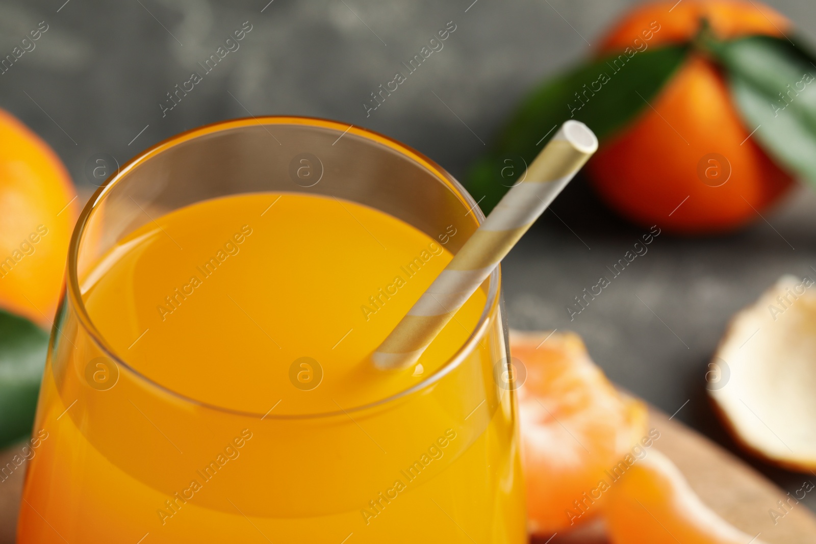 Photo of Glass of fresh tangerine juice, closeup view