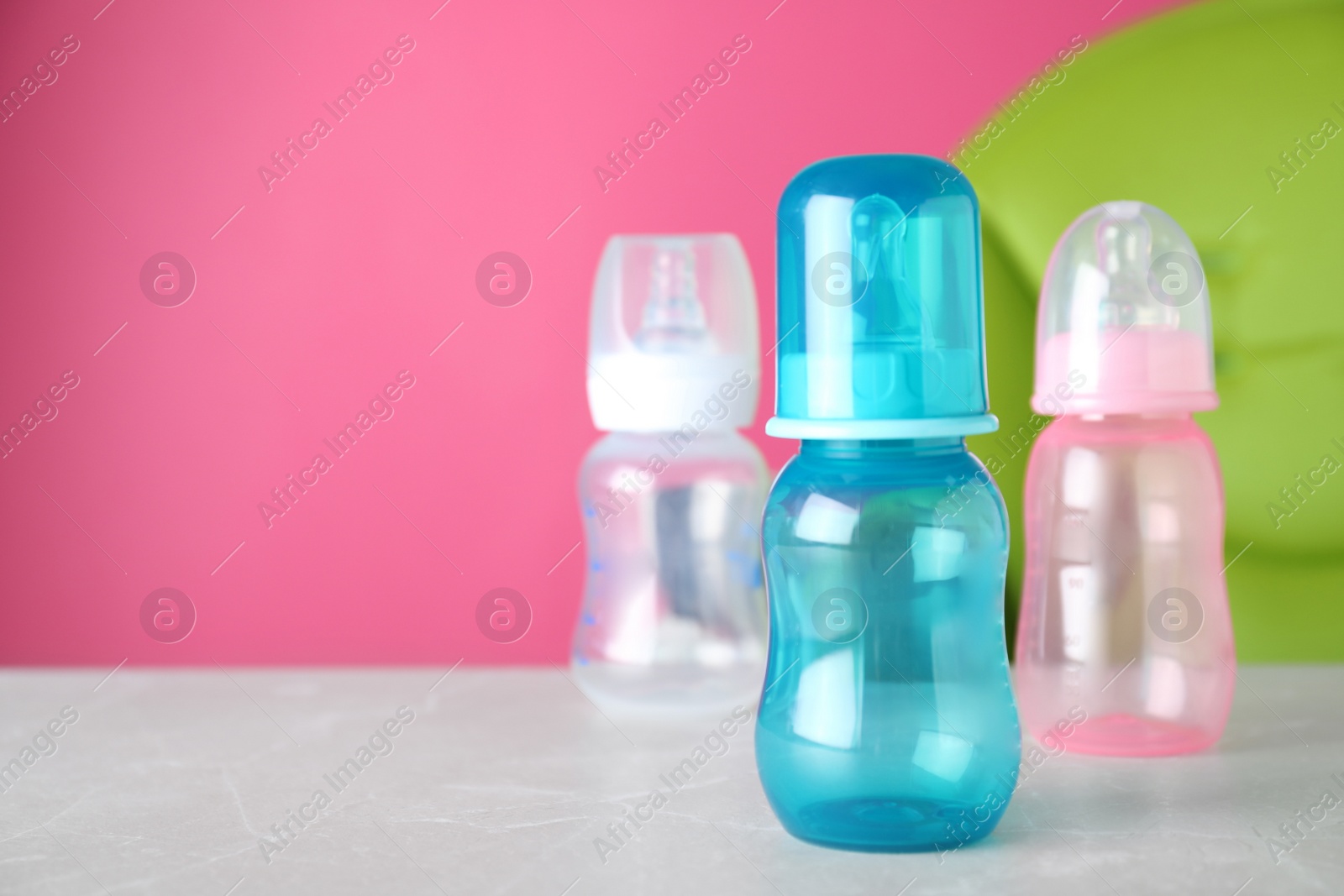 Photo of Set of plastic bottles on light table. Serving baby food