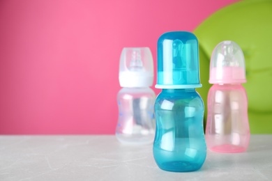 Set of plastic bottles on light table. Serving baby food