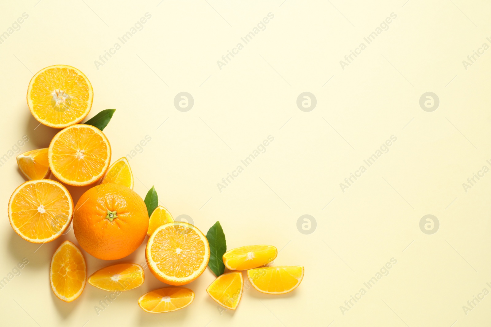 Photo of Flat lay composition with ripe oranges and space for text on color background