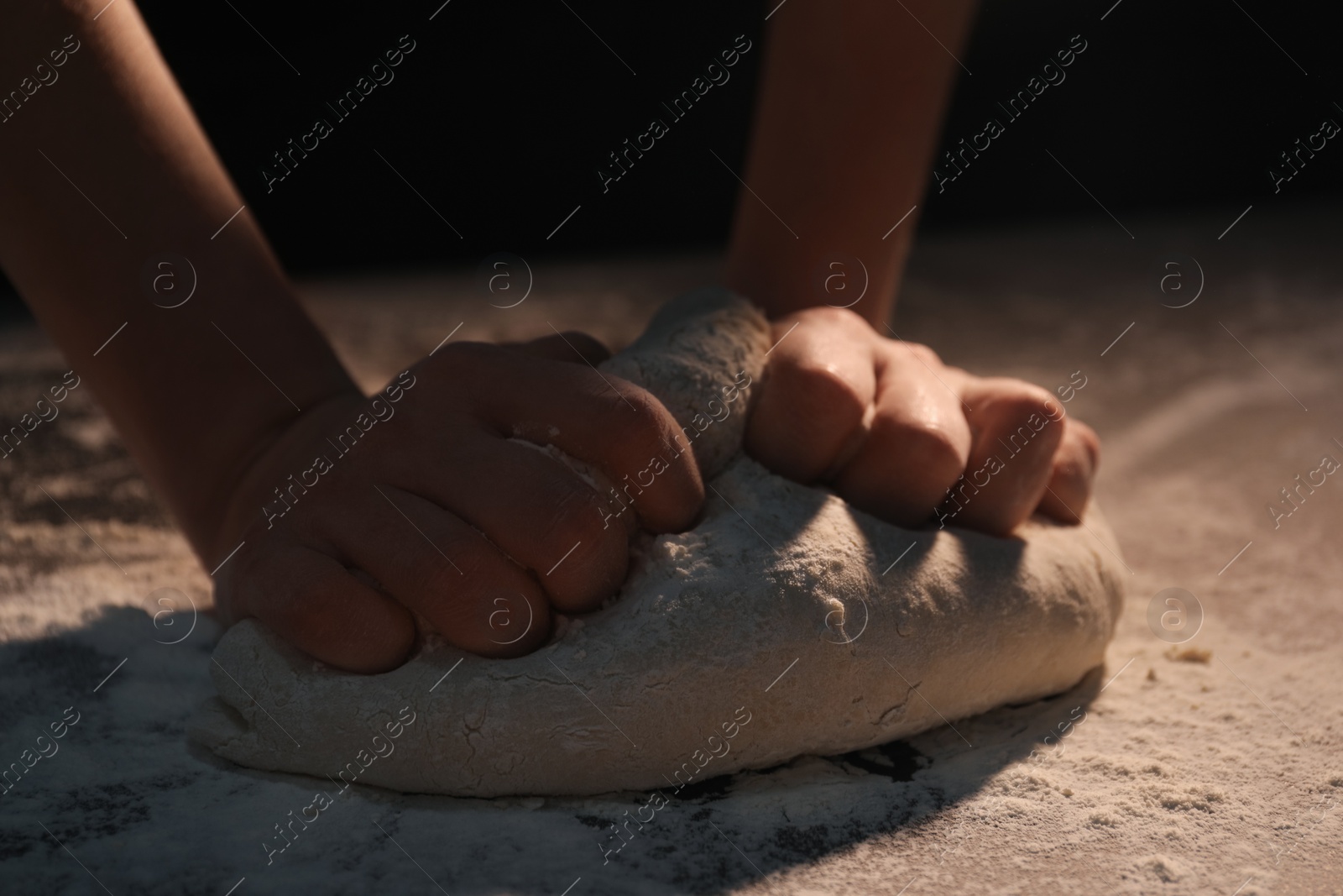 Photo of Making bread. Woman kneading dough at table, closeup