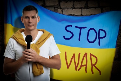 Image of Journalist near Ukrainian flag with words Stop War