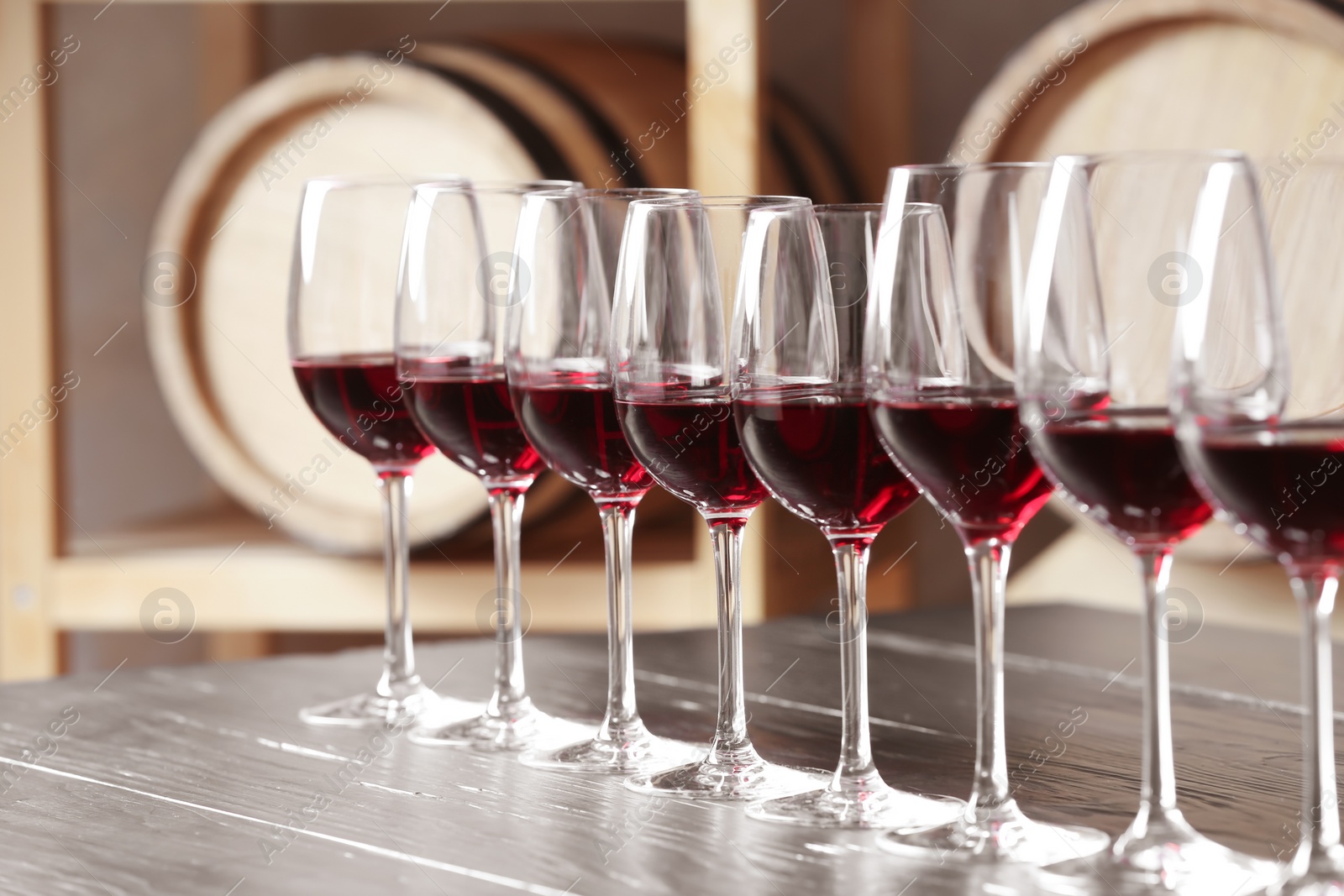 Photo of Glasses with delicious red wine on table