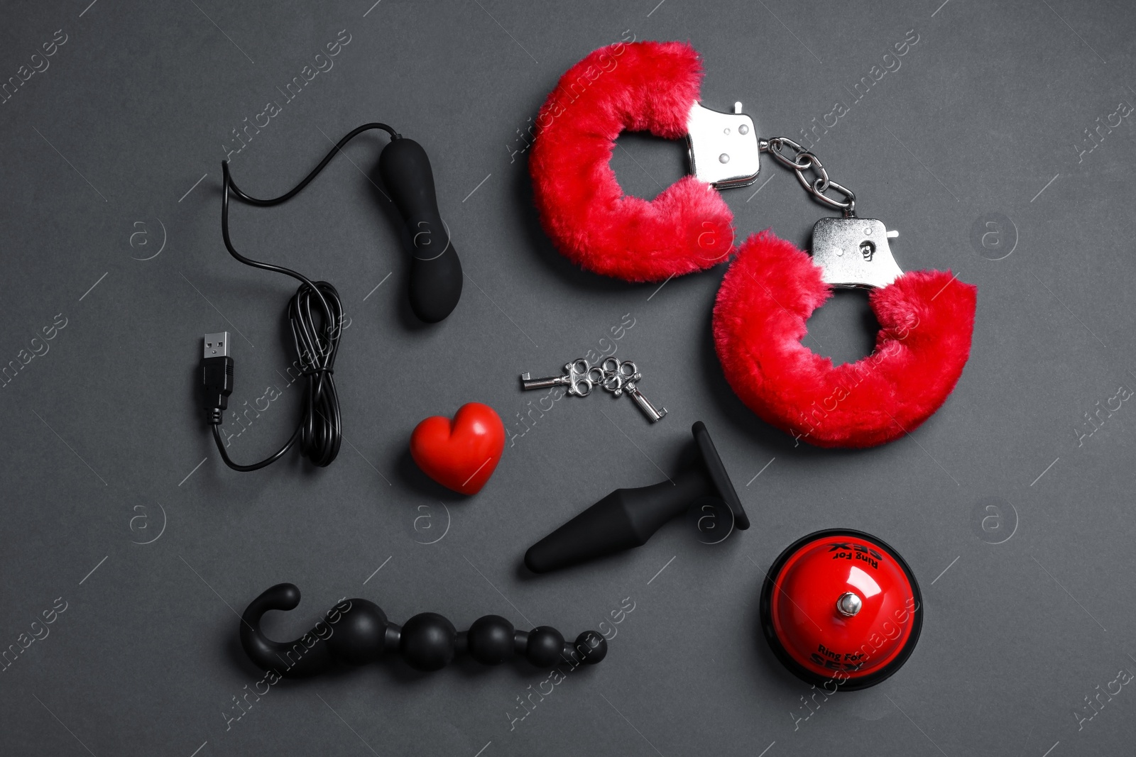 Photo of Different sex toys on dark background, flat lay