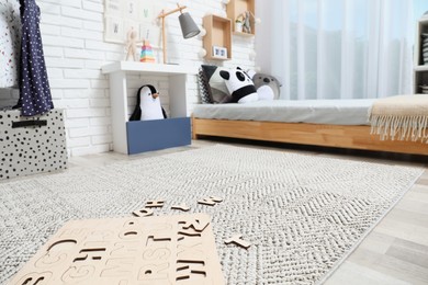 Photo of Montessori bedroom interior with floor bed and toys