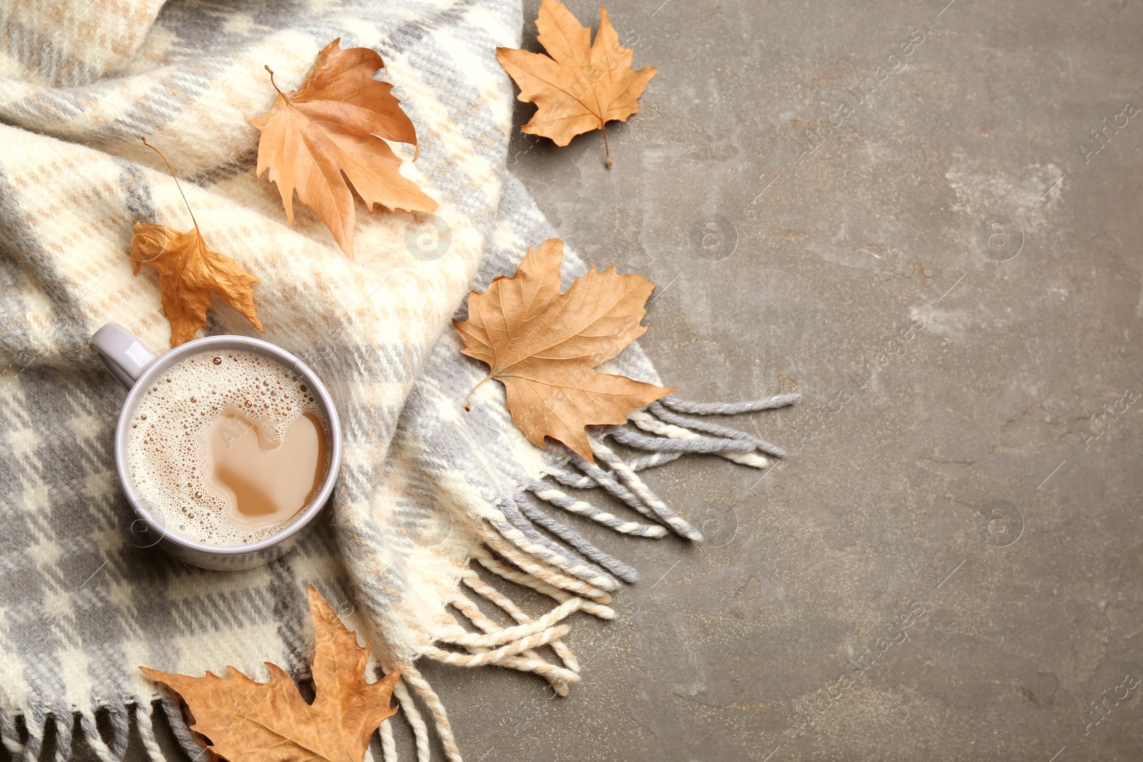 Photo of Flat lay composition with coffee and warm plaid on grey table, space for text