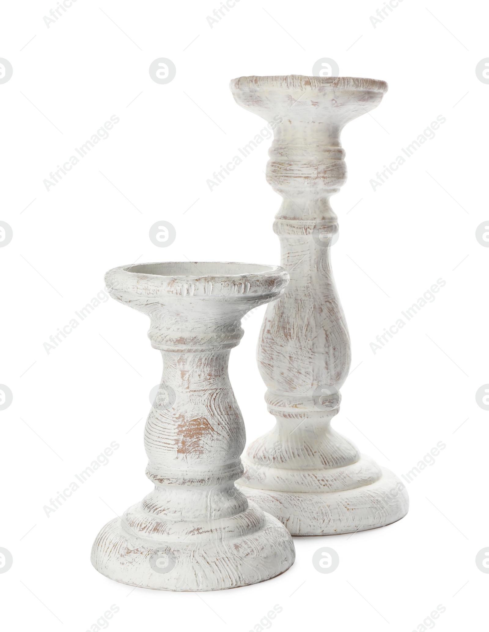 Photo of Two stylish wooden candlesticks on white background