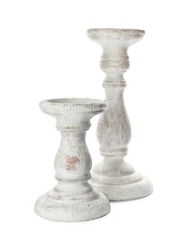 Two stylish wooden candlesticks on white background