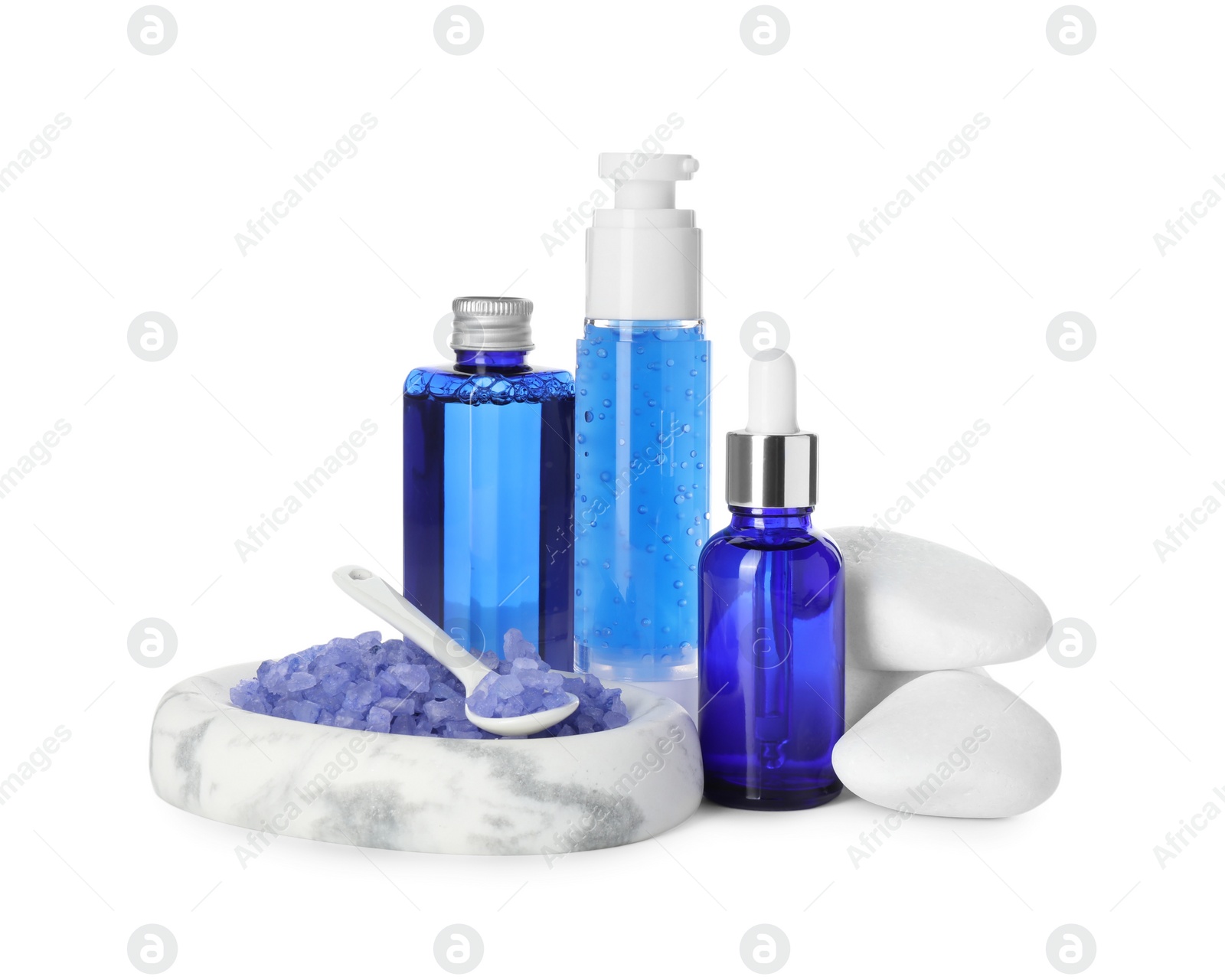 Photo of Spa composition. Bottles of cosmetic products, stones and sea salt isolated on white