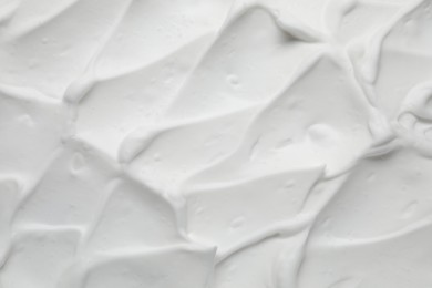 Photo of Texture of white shaving foam as background, top view