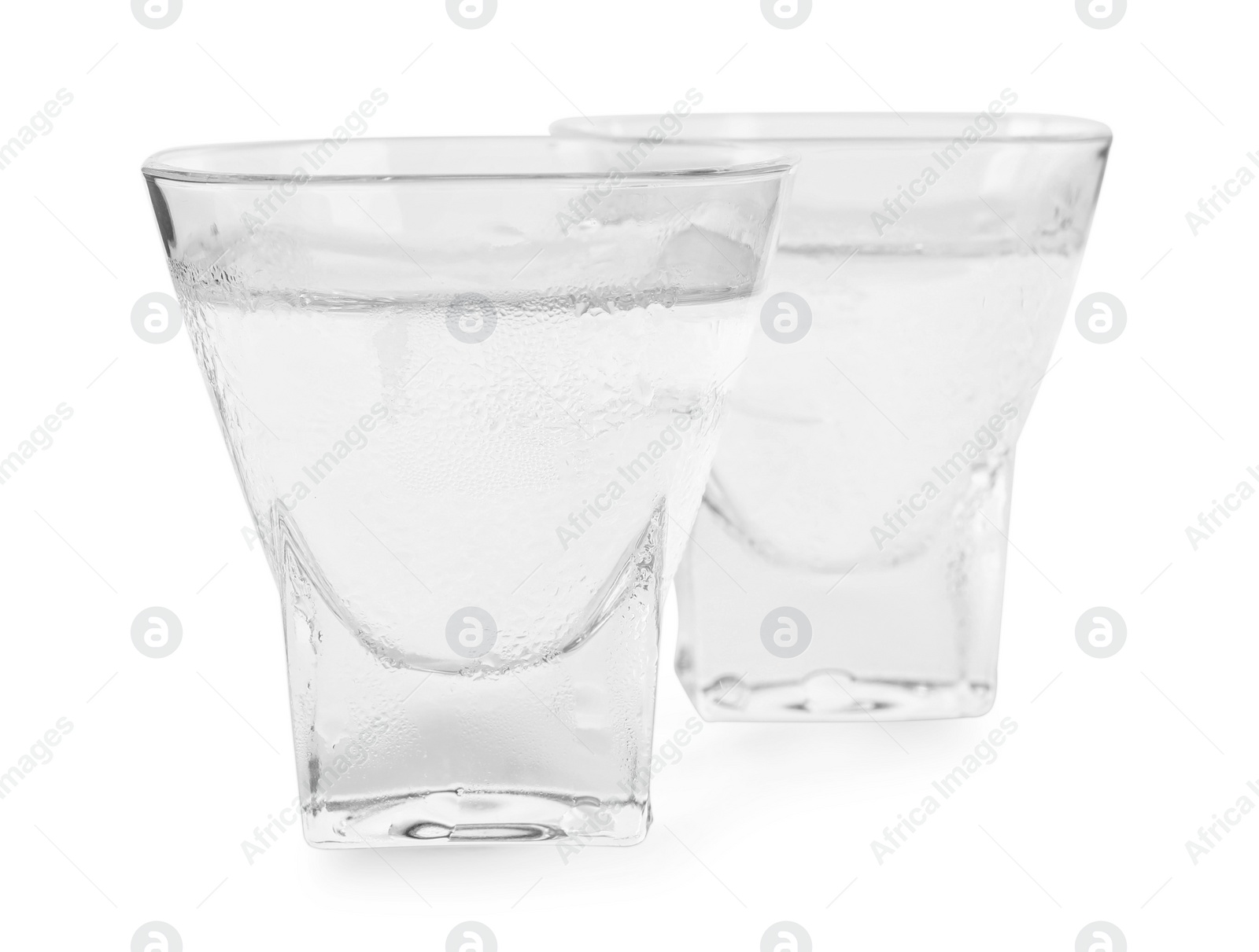 Photo of Vodka in shot glasses on white background