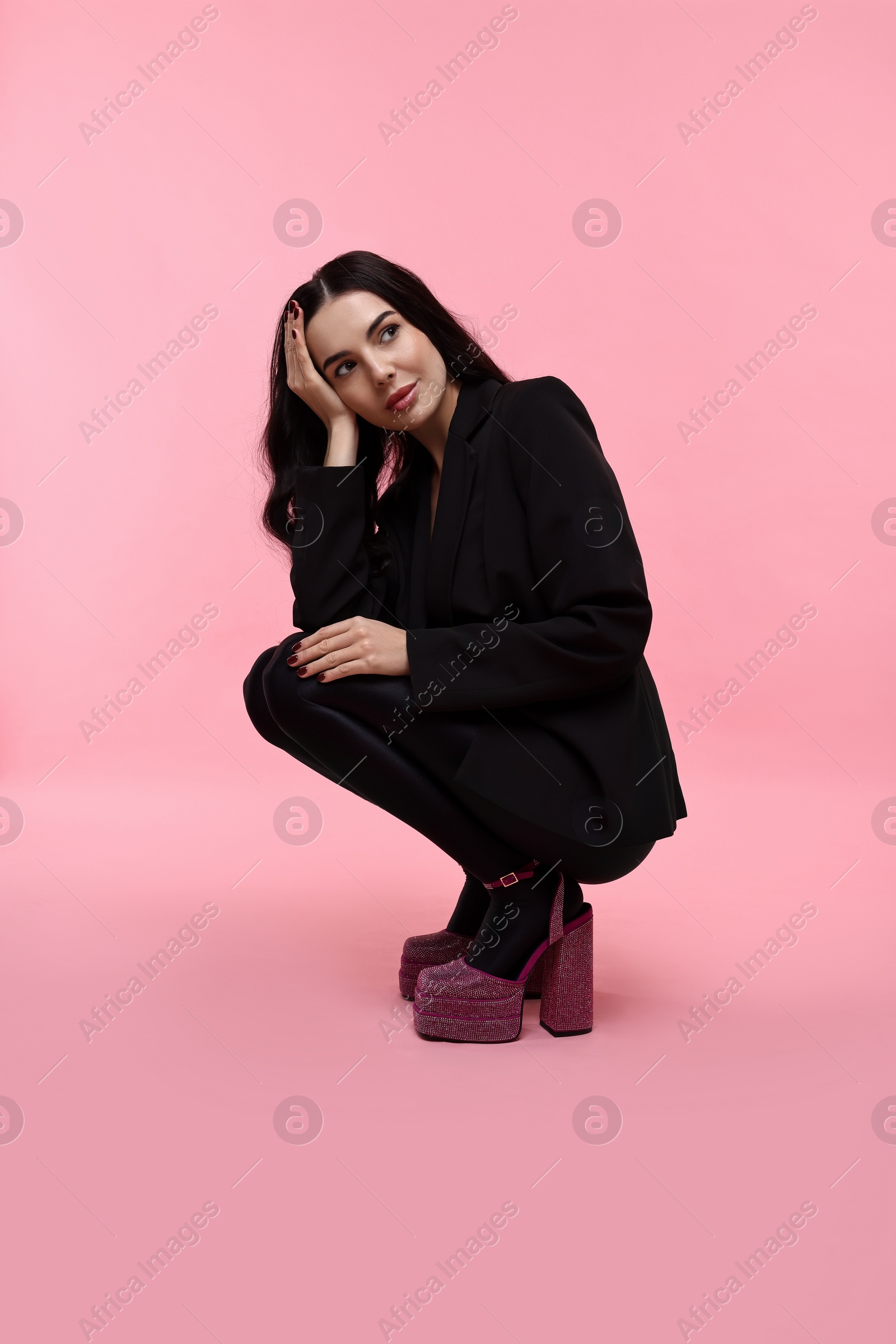 Photo of Stylish woman in black jacket on pink background