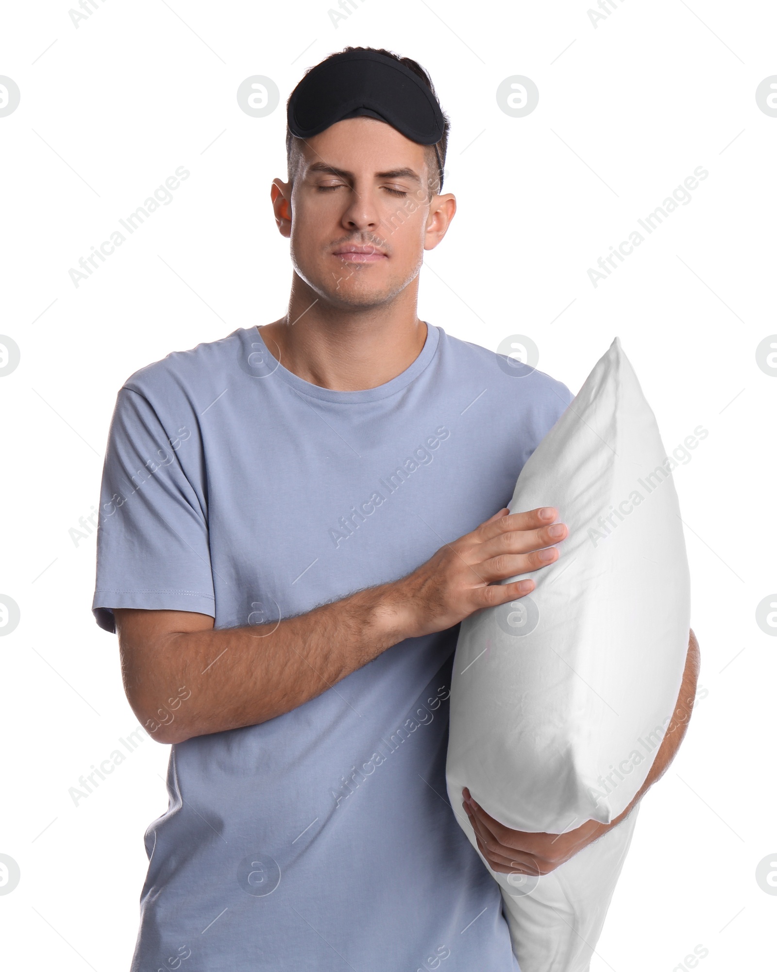 Photo of Somnambulist with blindfold and soft pillow on white background. Sleepwalking