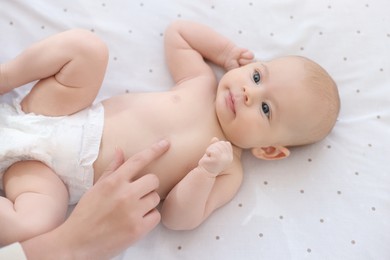 Photo of Mother with her cute little baby in crib