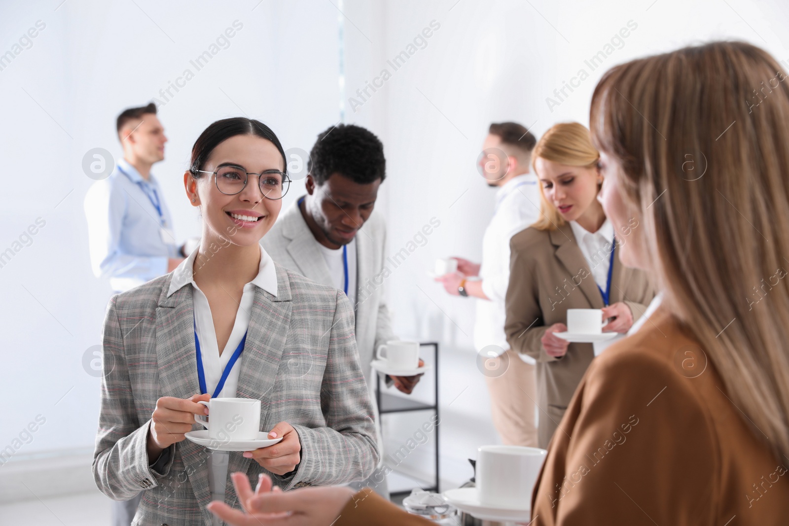 Photo of Group of people chatting during coffee break indoors