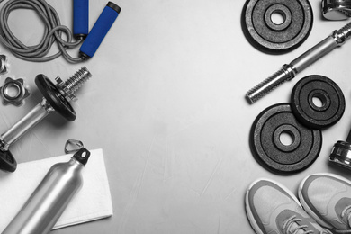Photo of Gym equipment on light grey background, flat lay