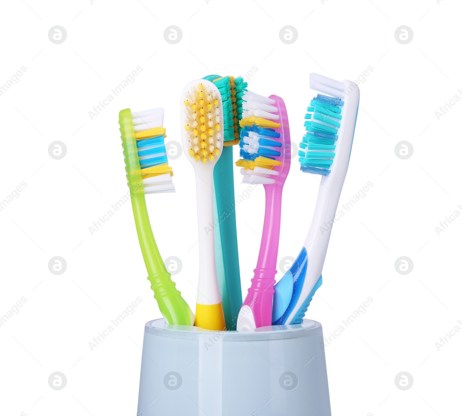 Photo of Different toothbrushes in holder isolated on white