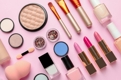 Flat lay composition with decorative cosmetics on color background