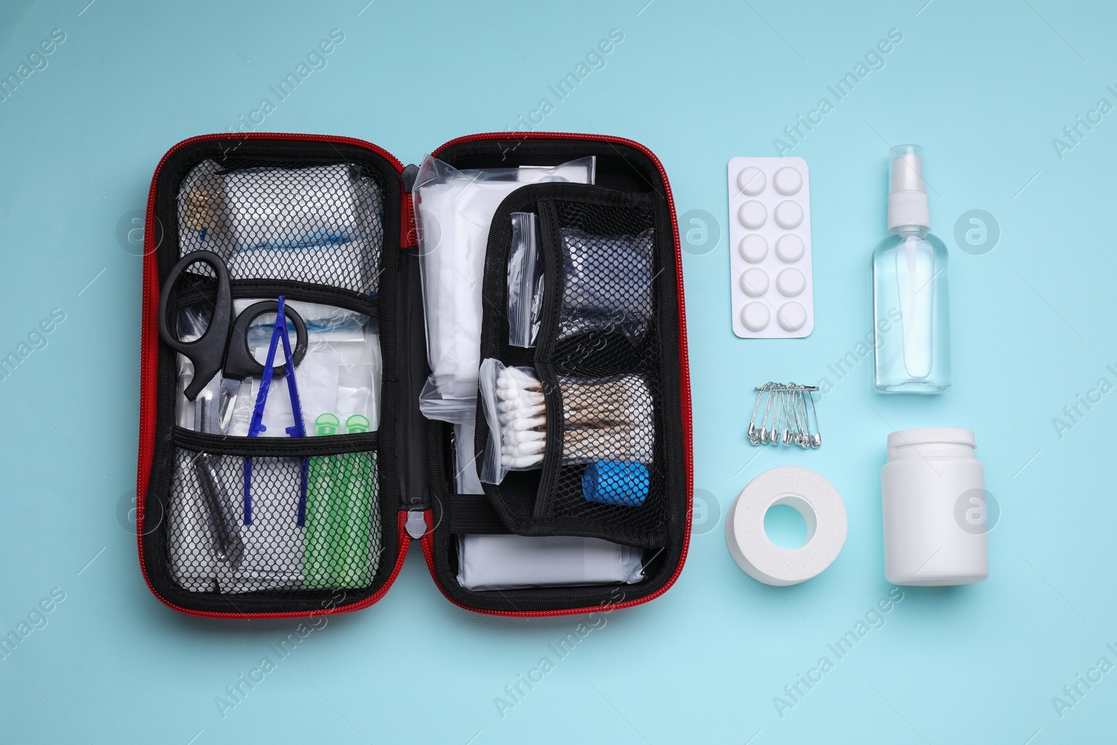 Photo of Flat lay composition with first aid kit on light blue background