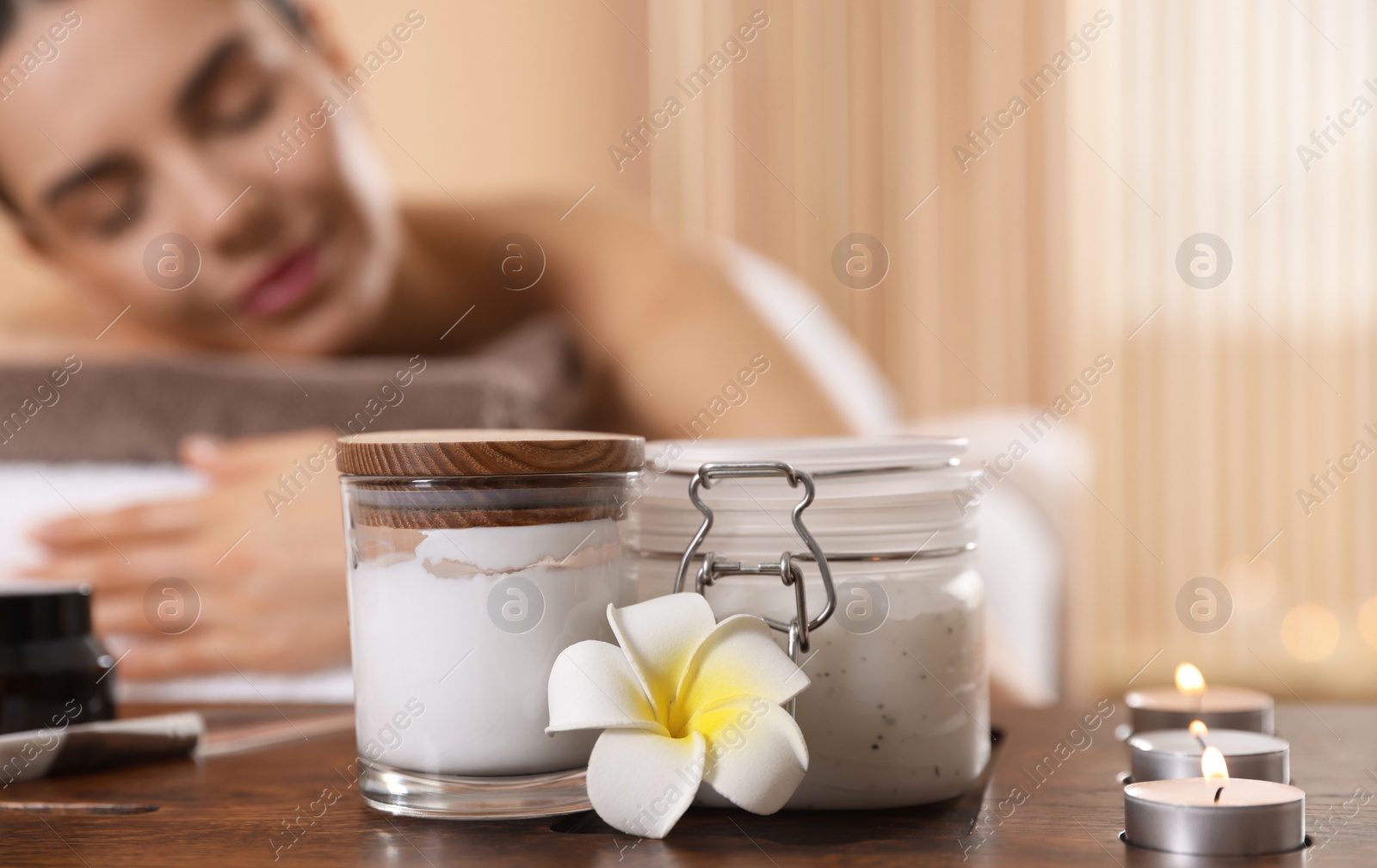 Photo of Young woman resting on massage couch in spa salon, selective focus