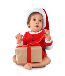 Photo of Festively dressed baby with gift box on white background. Christmas celebration