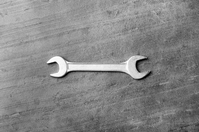 New wrench on grey background, top view. Plumber tools