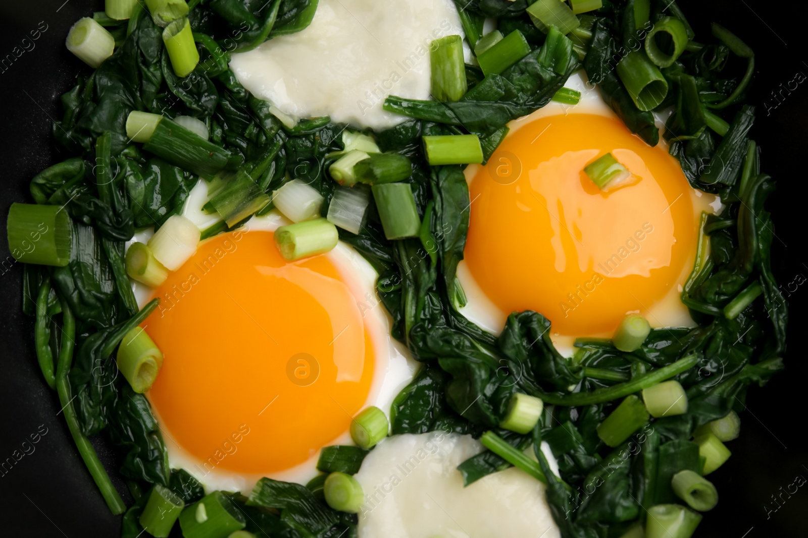 Photo of Tasty green Shakshouka in frying pan, top view