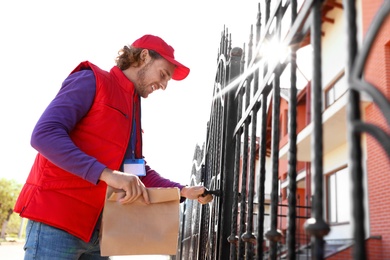Photo of Male courier delivering food in city on sunny day