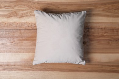 Photo of Blank soft pillow on wooden background, top view