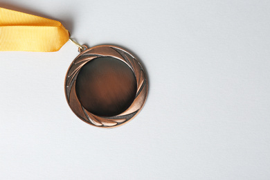 Photo of Bronze medal on white background, top view. Space for design