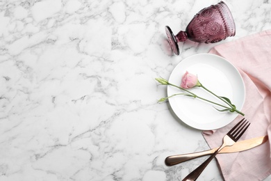 Elegant table setting on marble table, flat lay. Space for text