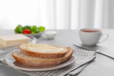 Photo of Fresh bread with tasty butter on plate