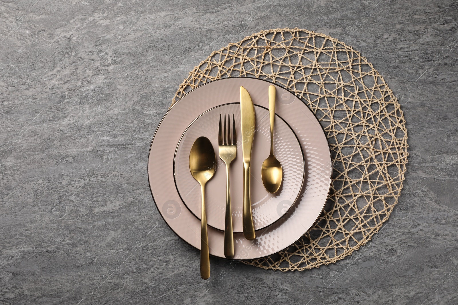 Photo of Stylish table setting with cutlery on grey surface, top view and space for text