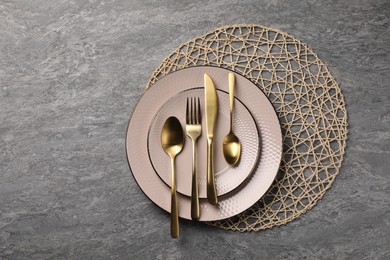 Stylish table setting with cutlery on grey surface, top view and space for text