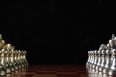 Photo of Chessboard with game pieces on black background. Space for text