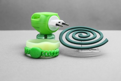 Set of different insect repellents on grey background
