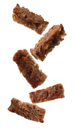 Image of Tasty rye croutons falling on white background